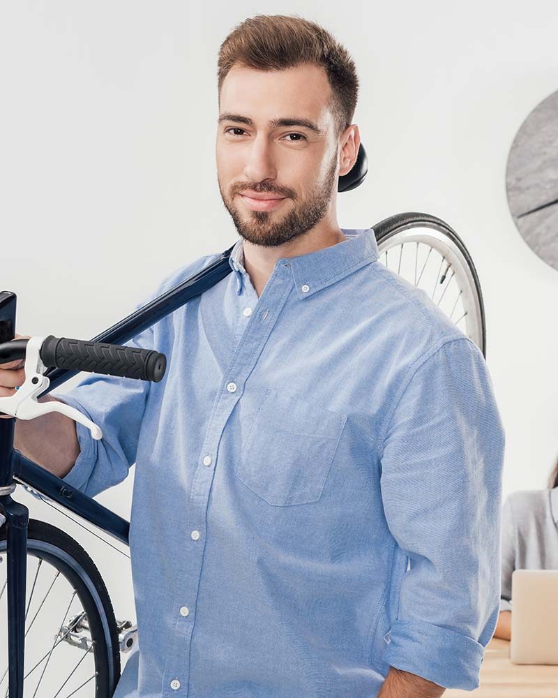 portrait-of-businessman-holding-bicycle-while-coll-CUM9ZRY.jpg